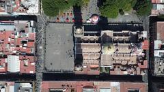 Aerial drone view of Catedral de Puebla showcasing its intricate architecture and surrounding buildings