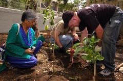 Master Chief Avionics Specialist Jeff Roan and Meena Y. Reddy planting trees in Chennai garden