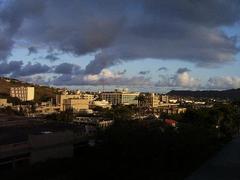 University of Hawaii campus landscape with modern buildings and lush greenery under a clear sky