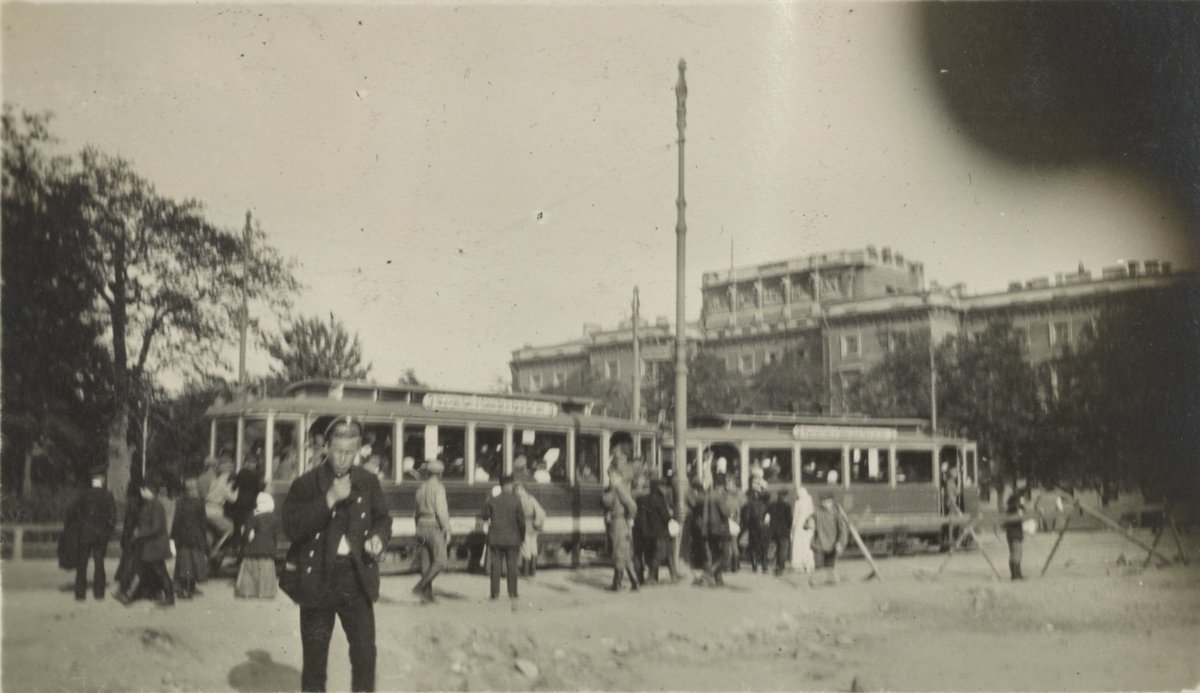 People and trams near St. Michael's Castle in Petrograd with women parading to the Duma and a moving van labeled Furstadtskaya