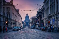 Street view from Place Royale along Rue de la Régence in Brussels towards the Courts of Law with museum pillars and church in background
