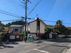 Scenic west side of Kamakura with traditional architecture and green hills under a blue sky