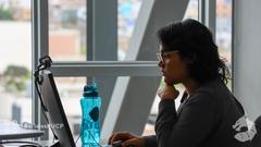 Female presenter looking at her laptop during an editathon event
