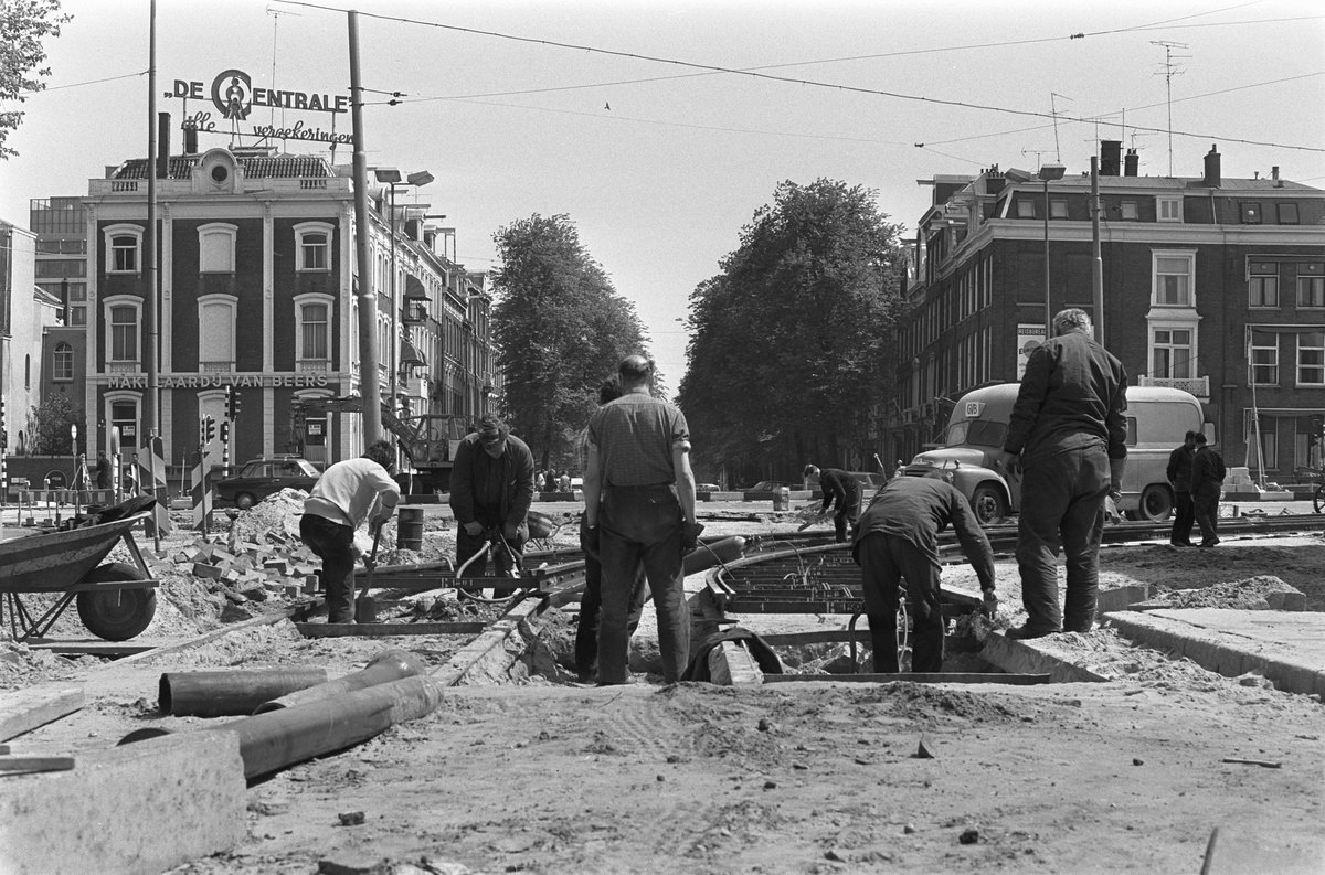 Construction workers laying tram rails during metro development in Wibautstraat, Amsterdam in 1972