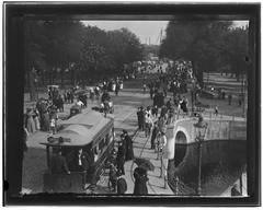 Historical view of Weesperplein in Amsterdam from the bridge over Nieuwe Achtergracht showing Westerpoortstation, a horse tram, and a royal visit