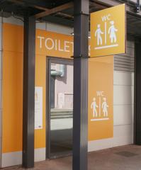 Closed public toilet at Lyon Part-Dieu train station showing locked doors and signage