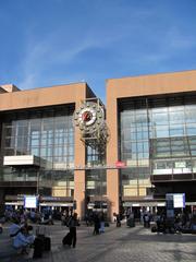 Interior view of Lyon Part-Dieu train station showing ticket counters and passengers