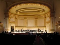 Main stage inside Carnegie Hall post-concert with performers and audience