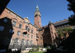 Town Hall of Copenhagen surrounded by Rådhushaven garden with blooming flowers and greenery