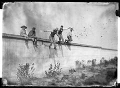 Children sitting and young men jumping from a wall at the Observatory in Toulouse
