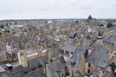 Panoramic view of Dinan with historic buildings and a winding river under a clear sky