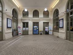 Entrance hall of Lyon-Saint-Paul train station north side with architectural details and commuters