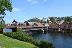 The Old Town Bridge Gamle Bybro in Trondheim Norway at dusk with illuminated bridge and cityscape