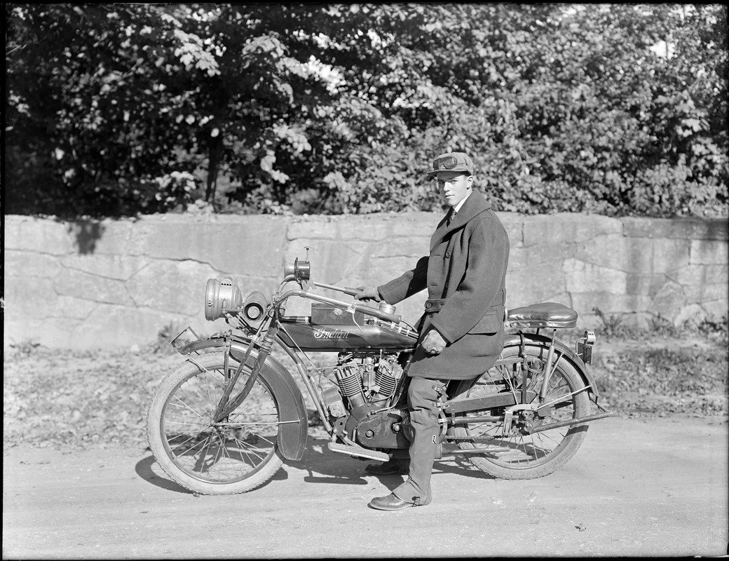 Phillip Smith riding an Indian motorcycle on Perkins Street near Ward's Pond
