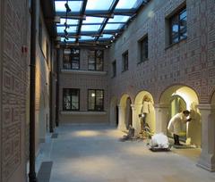 Two sculptors working on sculptures in the Museum of Warsaw workshop