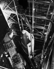 Space Shuttle Orbiter Enterprise being lowered into the vibration test stand at Marshall Space Flight Center