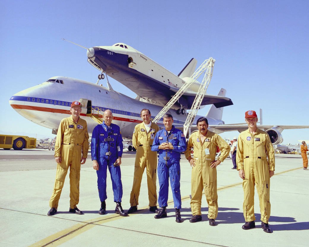 Flight crews of space shuttle prototype Enterprise and NASA's Boeing 747 Shuttle Carrier Aircraft in front of their piggyback pair after final captive-carry flight in 1977