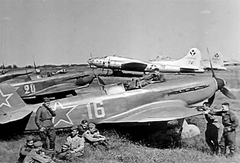 USAAF B-17 Flying Fortresses and Soviet Yakovlev Yak-9 fighters at airfield 1944
