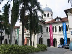 Exterior view of Singapore Art Museum with modern architectural design and people walking around