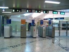 Interior of Jardim Zoológico Metro Station in Lisboa with escalators and a yellow tactile guide path