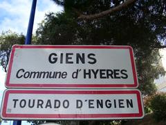Entrance sign to Giens in French Riviera, featuring white letters on blue background