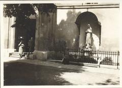Vintage black and white photo of a Hungarian family sitting together on a bench outdoors