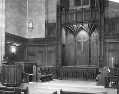 Original chancel of Park Avenue Baptist Church with wooden pews and decorative elements