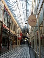Passage Jouffroy in Paris interior with glass roof and ornate ironwork
