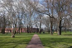 Park inside Warsaw Citadel with trees and paved walkway