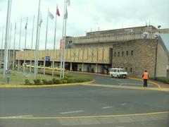 Arrival Terminal at Nairobi Airport with travelers and vehicles