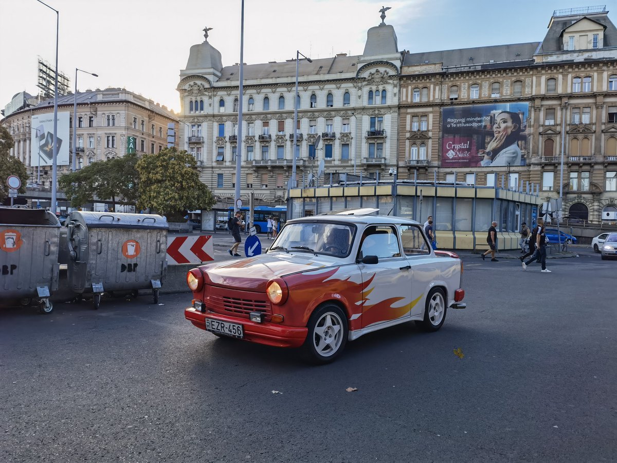 Budapest Nyugati railway station with a vintage Trabant car in the foreground