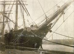 Bow and ornate scroll head of the four-masted barque ship Moshulu at wharf