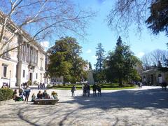 Paseo del Prado street in Madrid with historic buildings and clear blue sky