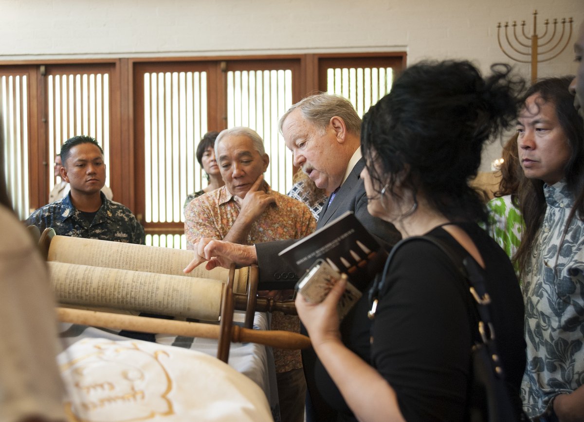 Reform Jewish Educator Daniel A Bender showing a Holocaust Torah to service members and civilians during Holocaust Remembrance Day ceremony at Aloha Jewish Chapel