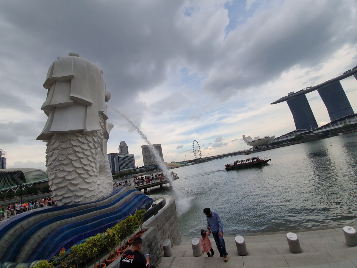 Family posing at Merlion statue in Singapore