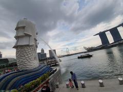 Family posing at Merlion statue in Singapore