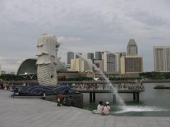 Merlion statue at night in Singapore with colorful lights