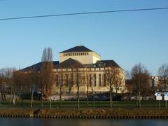 Staatstheater Saarbrücken building exterior under blue sky with trees