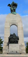 National War Memorial illuminated at night with a dramatic sky