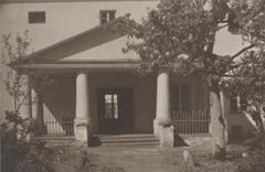 Historical street scene in Vilnia showing a narrow alley and a visible monastery from 1919