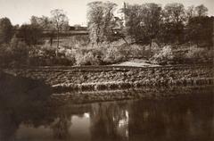 Historical black and white photo of Vilnia's Misijanerski pond area and Rosy lane with a visible monastery in the background