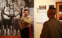 Major General Juan G. Ayala visiting the Centennial Museum and Gardens at UTEP pointing at a 1966 NCAA Basketball Champions photograph