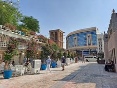 Traditional courtyard in Al Bastakiya district with beige wind towers and wooden accents