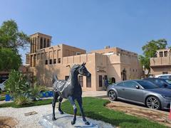 Traditional wind towers in Al Bastakiya district of Dubai under clear blue sky