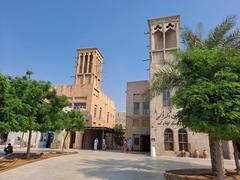 Traditional beige buildings with wooden lattice windows and a narrow alley in Al Bastakiya Dubai