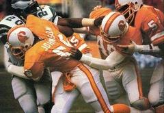 1986 Jeno's Pizza NFL football card #20 featuring Tampa Bay Buccaneers linebacker Cecil Johnson tackling Philadelphia Eagles running back Leroy Harris in 1979 NFC Divisional Playoff
