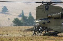 U.S. Soldiers boarding CH-47 Chinook helicopter during mission rehearsal at Joint Multinational Readiness Center in Germany