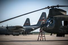 U.S. Army Staff Sgt. Justin Marshall washing cockpit windows of CH-47 Chinook helicopter during preflight check at Alpena Combat Readiness Training Center