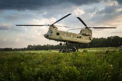 U.S. Soldiers from 82nd Airborne Division Artillery attaching reach pendant to CH-47 Chinook cargo hook during live fire exercise at Fort Bragg