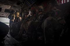 U.S. Army special tactics personnel preparing mentally inside an MH-47 Chinook helicopter during night infiltration and exfiltration exercises at Gulfport Combat Readiness Training Center